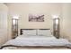 Bedroom featuring hardwood floors, modern lamps, and a decorative city scene painting at 1555 California St # 304, Denver, CO 80202