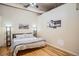 Bright and open bedroom with hardwood floors, fan, lofted ceiling, and modern decor at 1555 California St # 304, Denver, CO 80202