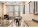 Dining area adjacent to kitchen with exposed pipes and large windows, perfect for entertaining at 1555 California St # 304, Denver, CO 80202