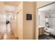 Hallway with wood floors leading to the bathroom with convenient hall closet at 1555 California St # 304, Denver, CO 80202