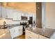 Modern kitchen features stainless steel appliances, white cabinets, and granite countertops at 1555 California St # 304, Denver, CO 80202