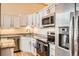 Modern kitchen featuring stainless steel appliances and sleek countertops, ideal for cooking and dining at 1555 California St # 304, Denver, CO 80202