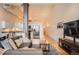 Comfortable living room with hardwood floors, modern furniture, and a connected kitchen at 1555 California St # 304, Denver, CO 80202