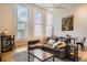 Comfortable living room featuring large windows, hardwood floors, and stylish furnishings at 1555 California St # 304, Denver, CO 80202