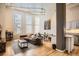 Spacious living room with hardwood floors, exposed duct work, large windows, and modern decor at 1555 California St # 304, Denver, CO 80202