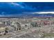 Scenic aerial view of a residential community with mountain backdrop under a dramatic sky at 1734 Peak Prairie Ln, Monument, CO 80132