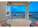 Covered back patio with seating and a beautiful view, perfect for enjoying the outdoors at 1734 Peak Prairie Ln, Monument, CO 80132