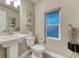 Charming powder bath with pedestal sink, patterned tile floor, and decorative accents at 1734 Peak Prairie Ln, Monument, CO 80132