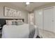Comfortable bedroom with soft carpet, a ceiling fan, a bed and an entrance to a closet at 1734 Peak Prairie Ln, Monument, CO 80132