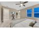 Bright bedroom with carpet, ceiling fan, a decorative plant, and a view of the outside at 1734 Peak Prairie Ln, Monument, CO 80132