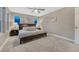 Spacious bedroom featuring windows, ceiling fan, lamps, bedside tables, and a bed at 1734 Peak Prairie Ln, Monument, CO 80132