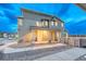 Charming two-story home featuring a covered porch, stone accents, and inviting curb appeal at 1734 Peak Prairie Ln, Monument, CO 80132