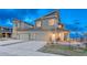Two story home featuring a two car garage, stone porch accents and low maintenance front yard at 1734 Peak Prairie Ln, Monument, CO 80132