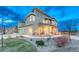 Charming two-story home with manicured landscaping and welcoming front porch at 1734 Peak Prairie Ln, Monument, CO 80132