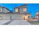 Contemporary two-story home featuring a gray exterior, a two-car garage, and modern design at 1734 Peak Prairie Ln, Monument, CO 80132