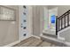 Bright foyer with modern front door and staircase leading to the upper level at 1734 Peak Prairie Ln, Monument, CO 80132