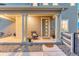 Inviting front porch with stylish chair, potted plants, and a welcoming entrance at 1734 Peak Prairie Ln, Monument, CO 80132