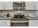 Modern kitchen features stainless steel appliances and light gray countertops at 1734 Peak Prairie Ln, Monument, CO 80132