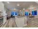 Open kitchen with bar stool seating that flows into the living and dining rooms at 1734 Peak Prairie Ln, Monument, CO 80132