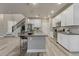 Modern kitchen features a large island, stainless appliances, and stylish light gray countertops at 1734 Peak Prairie Ln, Monument, CO 80132