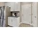 Bright kitchen features stainless steel refrigerator and white cabinets and countertops at 1734 Peak Prairie Ln, Monument, CO 80132