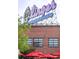 Exterior view of a brick building with the 'LINGER EATUARIES' neon sign and red umbrellas at 3069 Tejon St # B, Denver, CO 80211
