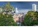 Scenic city view featuring modern architecture, visible through lush green trees at 3069 Tejon St # B, Denver, CO 80211