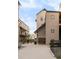 Back exterior view with multiple units, concrete ground cover, outdoor seating and secure black fence at 3069 Tejon St # B, Denver, CO 80211