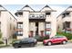 Charming townhome with red doors and black awnings, complemented by a well-maintained exterior and convenient parking at 3069 Tejon St # B, Denver, CO 80211