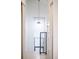Bright hallway featuring a modern light fixture and access to additional rooms, blending style and functionality at 3069 Tejon St # B, Denver, CO 80211