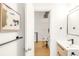 Bright hallway leading to a bathroom, featuring modern art and decor at 3069 Tejon St # B, Denver, CO 80211