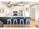 Stylish kitchen with stainless steel appliances and modern lighting above the breakfast bar with seating at 3069 Tejon St # B, Denver, CO 80211