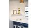 Close-up of kitchen counter featuring modern decor, bright lighting, and stylish barstools at 3069 Tejon St # B, Denver, CO 80211