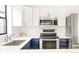 Bright kitchen featuring stainless steel appliances and sleek white countertops at 3069 Tejon St # B, Denver, CO 80211