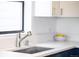 Close-up of a modern kitchen sink with stainless steel faucet and white countertops at 3069 Tejon St # B, Denver, CO 80211