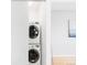 A modern laundry room featuring a stacked washer and dryer unit in a bright, minimalist space at 3069 Tejon St # B, Denver, CO 80211