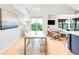 Bright living room with modern furnishings, dining area, and balcony access at 3069 Tejon St # B, Denver, CO 80211