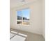 Bright bedroom featuring a large window with neighborhood views and neutral carpeting at 6153 N Ceylon St # 203, Denver, CO 80249