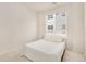 Bright bedroom with one window and all white decor at 6153 N Ceylon St # 203, Denver, CO 80249