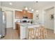 Bright kitchen features wood cabinets, stainless steel appliances, granite counters and pendant lighting at 6153 N Ceylon St # 203, Denver, CO 80249