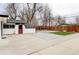 Spacious backyard with stone patio, artificial turf, wooden fence and a small shed at 2252 Harlan St, Edgewater, CO 80214