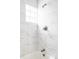 Bright bathroom with marble tile shower and tub, complemented by a clean and modern design at 2252 Harlan St, Edgewater, CO 80214