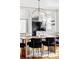 Dining area with modern lighting, open to the kitchen, providing an inviting flow at 2252 Harlan St, Edgewater, CO 80214