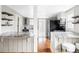 Modern kitchen features stone counters, wooden floors, and stainless appliances at 2252 Harlan St, Edgewater, CO 80214