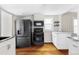 Updated kitchen boasts stainless steel appliances, stone countertops, and a seamless design at 2252 Harlan St, Edgewater, CO 80214