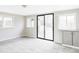 Spacious living room with ample natural light, sliding glass door, and neutral colors at 2252 Harlan St, Edgewater, CO 80214