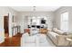 Bright, open-concept living room boasts hardwood floors and stylish decor, perfect for entertaining at 2252 Harlan St, Edgewater, CO 80214