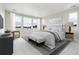 Serene bedroom features large windows, a comfortable chair, and a plush bench at the end of the bed at 5566 Hickory Oaks Trl, Castle Rock, CO 80104