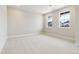 A comfortable bedroom with plush carpeting, large windows, and neutral walls at 5566 Hickory Oaks Trl, Castle Rock, CO 80104