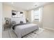 Bright bedroom with a large bed, neutral colors, and an abstract art piece above the headboard at 5566 Hickory Oaks Trl, Castle Rock, CO 80104